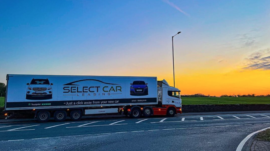 Promotional truck with bold, colorful branding, showcasing Truck Billboards UK's advertising services, driving on a city street.